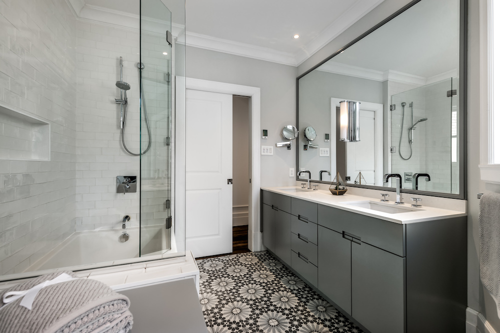 Modern bathroom in Newburyport, MA with patterned tile floor and double sink vanity